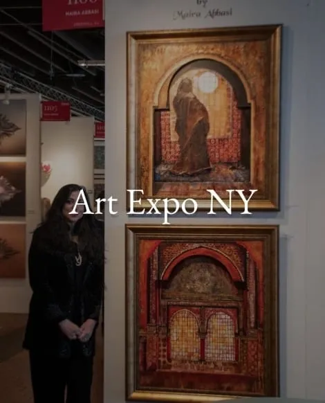 A woman standing in front of two paintings.